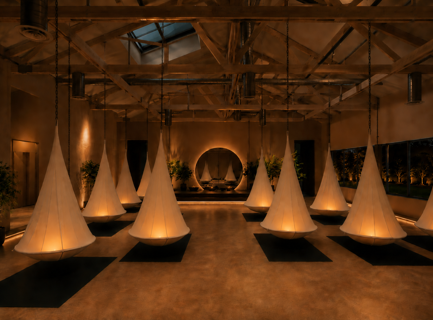 The Reset Room main floor with suspended pods under a skylight